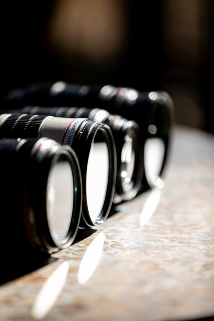 Camera lenses all lined up in a table