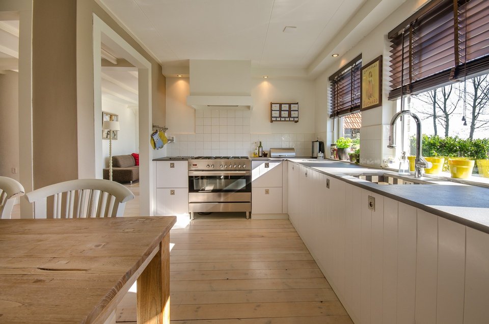 Kitchen interior with white countertops and wooden floors