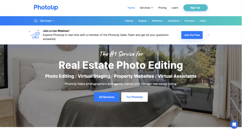 PhotoUp homepage shows a bedroom with a white bed frame that has gray and white bed sheets near a sliding glass window overlooking the lanai